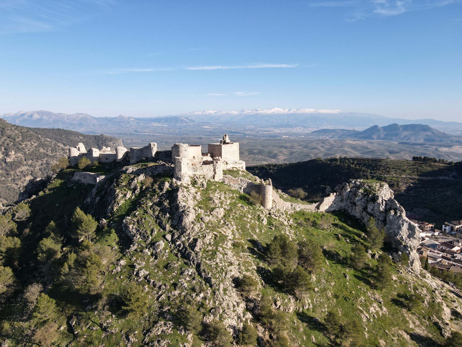 A hilltop fortress with the Sierra Nevada beyond